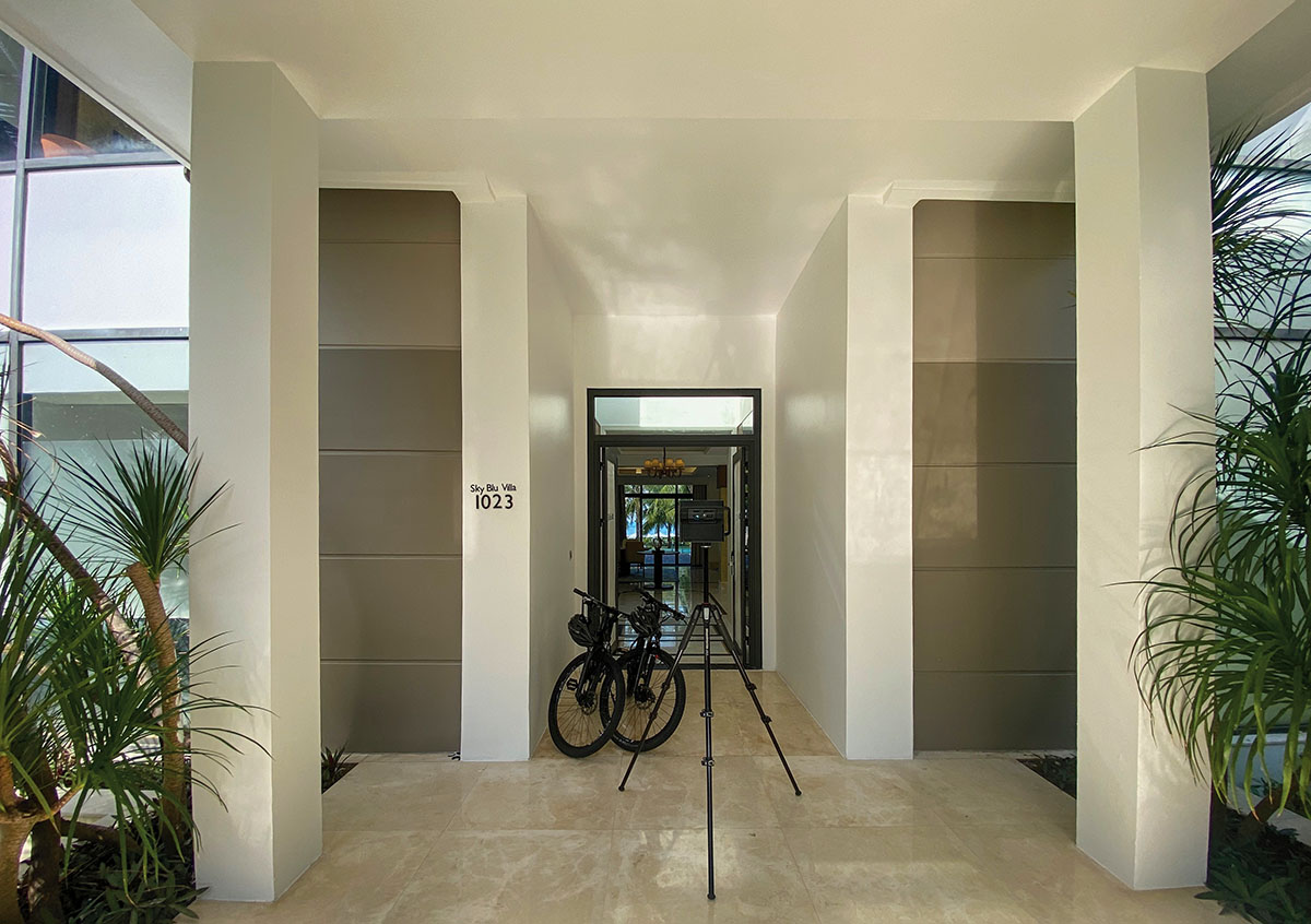 The entrance to Sky Blu Villa 1023 at Radisson Blu Resort Phu Quoc, with a Matterport scanner and two guest bicycles parked outside.