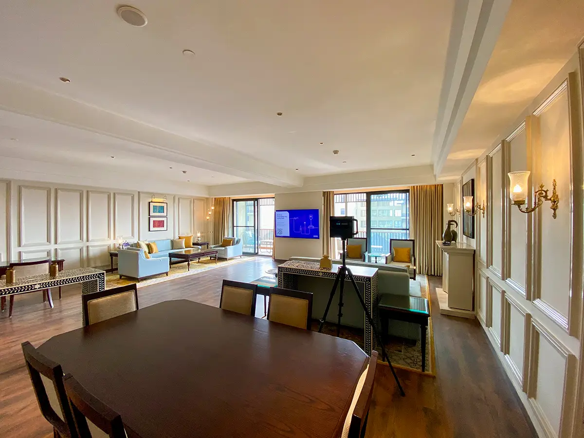 A person on a laptop exploring a vibrant Matterport virtual tour of a tropical resort.