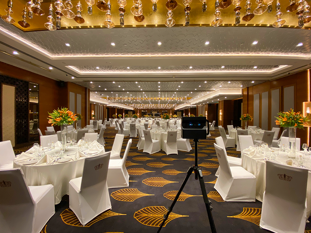 Hotel staff using a tablet to coordinate event setup