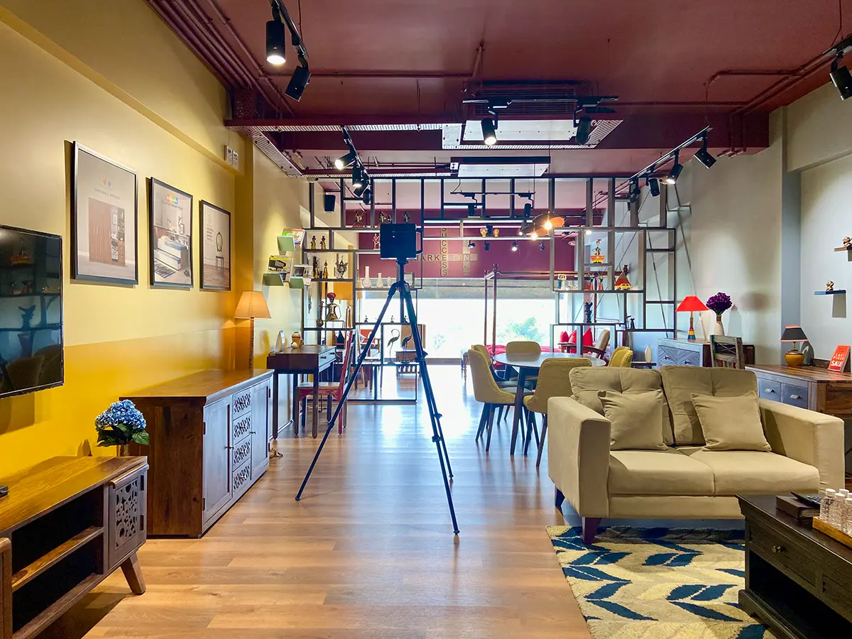 The interior of a high-end fashion boutique with clothes on display.